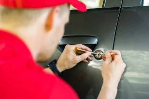 Customer using a car key with remote fob to unlock a vehicle door