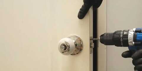 Locksmith drilling a door knob lock during an affordable service call in Florence, SC