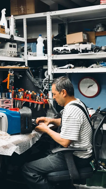 Locksmith working on lock hardware at a workbench
